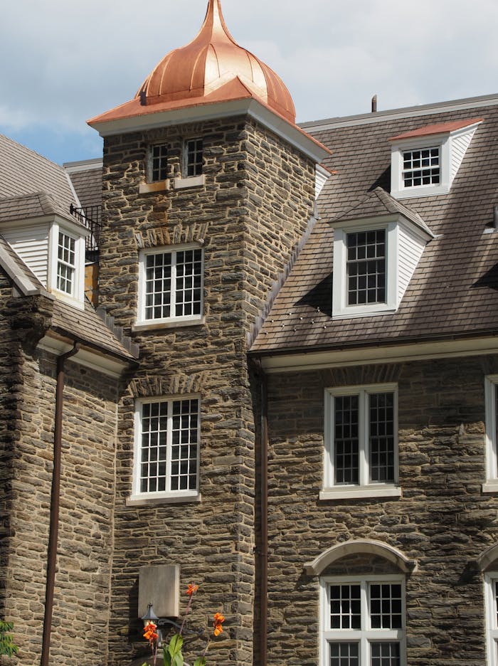 A classic stone building with unique copper dome roof in Pennsylvania, showcasing architectural charm.